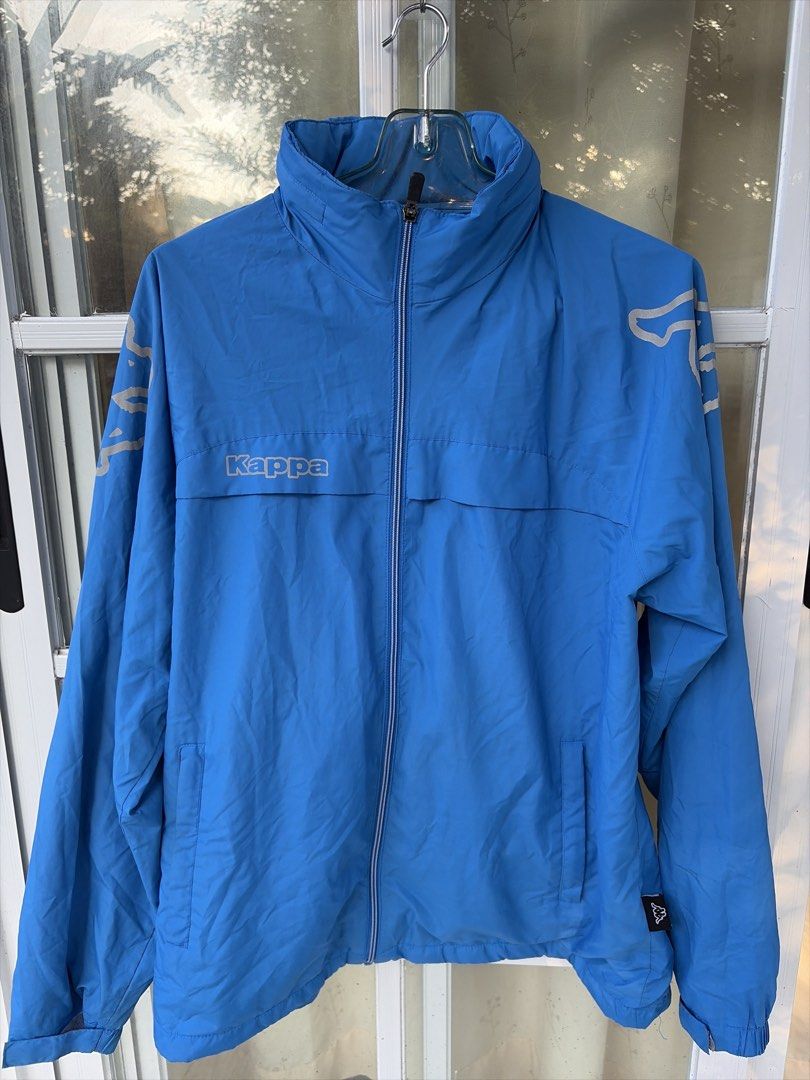 Kappa Blue Windbreaker Jacket (Category: Coats, Jackets and Outerwear) located in Bulacan. Submitted by aarchive (Listing ID 1463322373, Image 1). Description: - Blue Kappa jacket - Full zip closure with stand-up collar - Two front pockets - Kappa logo on chest and sleeves - Large Kappa logo on the back - Made of lightweight material - Ideal for outdoor activities or casual wear.