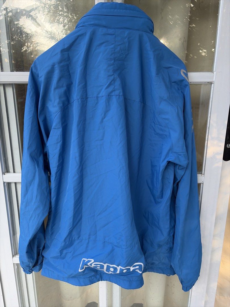 Kappa Blue Windbreaker Jacket (Category: Coats, Jackets and Outerwear) located in Bulacan. Submitted by aarchive (Listing ID 1463322373, Image 2). Description: - Blue Kappa jacket - Full zip closure with stand-up collar - Two front pockets - Kappa logo on chest and sleeves - Large Kappa logo on the back - Made of lightweight material - Ideal for outdoor activities or casual wear.