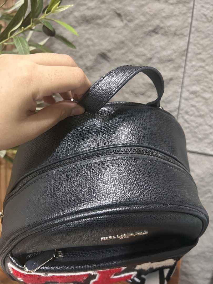 Karl Lagerfeld Backpack (Category: Backpacks) located in Muntinlupa City. Submitted by maryecious (Listing ID 1463254266, Image 3). Description: - Authentic Karl Lagerfeld Paris black leather backpack - Features iconic KL logo patches and Karl's face - Adjustable straps with Karl Lagerfeld branding - Convenient top handle for carrying - Multiple zipped compartments for secure storage - Ideal for everyday use and stylish on-the-go.