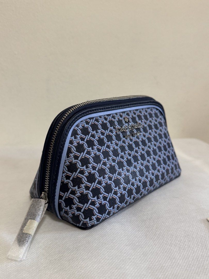 Kate Spade Cosmetic Bag - Navy Blue Chain Link Pattern (Category: Purses & Pouches) located in Bacoor. Submitted by nikkaroseee (Listing ID 1463151594, Image 2). Description: - Authentic Kate Spade cosmetic bag - Stylish navy blue and light blue chain link pattern - Secure zipper closure - Interior features signature spade pattern lining - Brand new with original tags and care card - Ideal for travel or everyday organization.