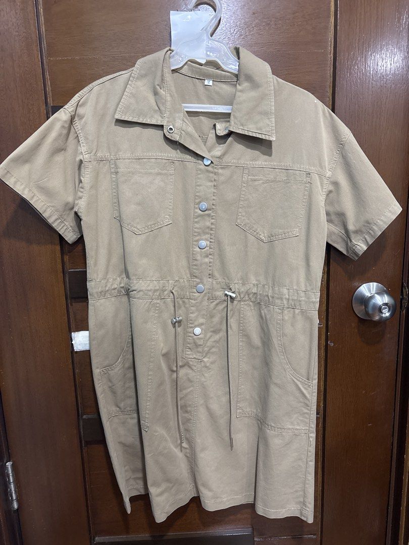 Khaki Button-Up Utility Dress with Drawstring Waist (Category: Dresses) located in Mandaluyong City. Submitted by clothescarousel (Listing ID 1463259692, Image 1). Description: - Khaki utility dress - Short sleeves - Collared neckline - Button-up front with silver buttons - Drawstring waist for a cinched silhouette - Two chest pockets - Two side pockets - Ideal for casual outfits.