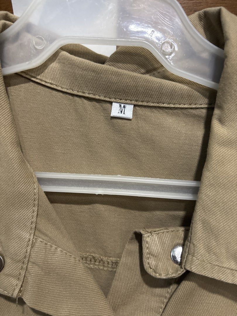 Khaki Button-Up Utility Dress with Drawstring Waist (Category: Dresses) located in Mandaluyong City. Submitted by clothescarousel (Listing ID 1463259692, Image 2). Description: - Khaki utility dress - Short sleeves - Collared neckline - Button-up front with silver buttons - Drawstring waist for a cinched silhouette - Two chest pockets - Two side pockets - Ideal for casual outfits.
