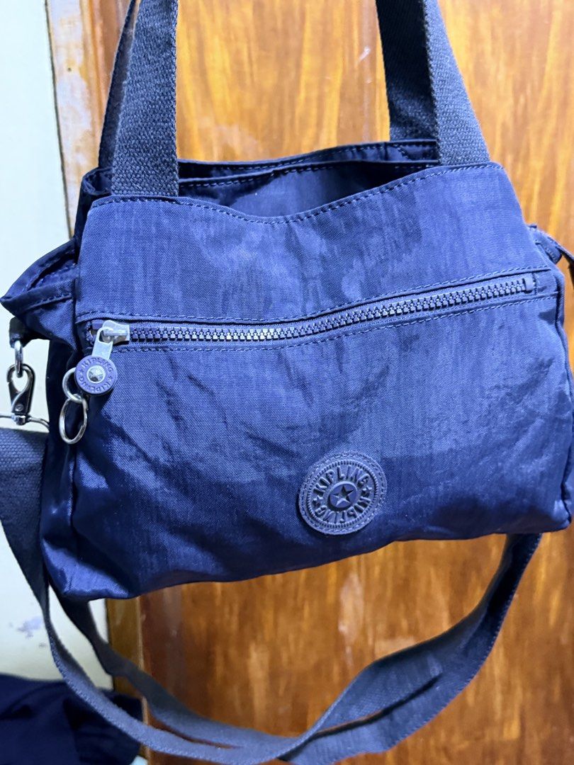 Kipling Navy Blue Nylon Tote Bag with Shoulder Strap (Category: Tote Bags) located in Paete. Submitted by skydruemadison (Listing ID 1463250009, Image 3). Description: - Navy blue Kipling bag - Made of durable nylon - Top handles and detachable shoulder strap - Multiple zippered compartments for organization - Spacious interior - Lightweight and perfect for everyday use.