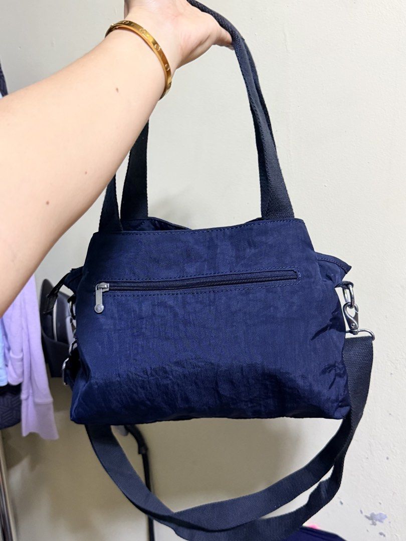 Kipling Navy Blue Nylon Tote Bag with Shoulder Strap (Category: Tote Bags) located in Paete. Submitted by skydruemadison (Listing ID 1463250009, Image 1). Description: - Navy blue Kipling bag - Made of durable nylon - Top handles and detachable shoulder strap - Multiple zippered compartments for organization - Spacious interior - Lightweight and perfect for everyday use.