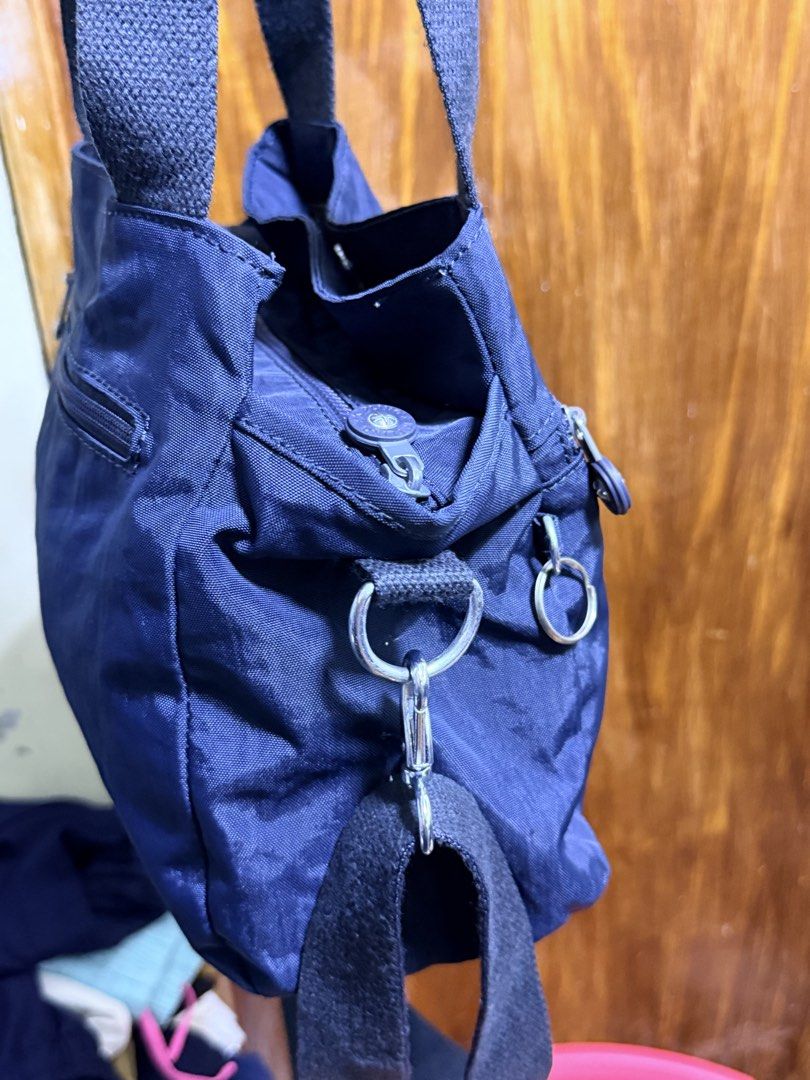 Kipling Navy Blue Nylon Tote Bag with Shoulder Strap (Category: Tote Bags) located in Paete. Submitted by skydruemadison (Listing ID 1463250009, Image 2). Description: - Navy blue Kipling bag - Made of durable nylon - Top handles and detachable shoulder strap - Multiple zippered compartments for organization - Spacious interior - Lightweight and perfect for everyday use.