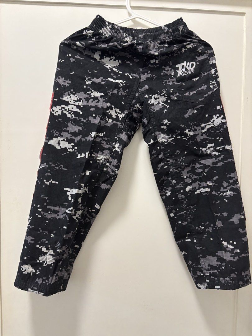 KIX Camouflage Taekwondo Training Pants - Size 4 (Category: Other Sports Equipment and Supplies) located in Manila. Submitted by mrstinq (Listing ID 1463259792, Image 2). Description: - Stylish black and grey digital camouflage pattern - Features a bold red stripe with Korean text on the side - Comfortable elastic waistband for a secure fit - KIX TKD GEAR branding on the back - Ideal for Taekwondo training sessions.