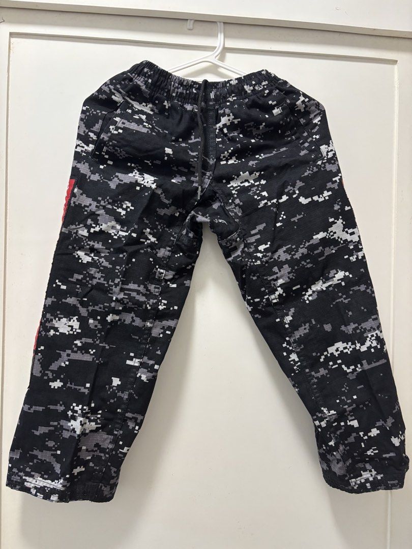 KIX Camouflage Taekwondo Training Pants - Size 4 (Category: Other Sports Equipment and Supplies) located in Manila. Submitted by mrstinq (Listing ID 1463259792, Image 1). Description: - Stylish black and grey digital camouflage pattern - Features a bold red stripe with Korean text on the side - Comfortable elastic waistband for a secure fit - KIX TKD GEAR branding on the back - Ideal for Taekwondo training sessions.