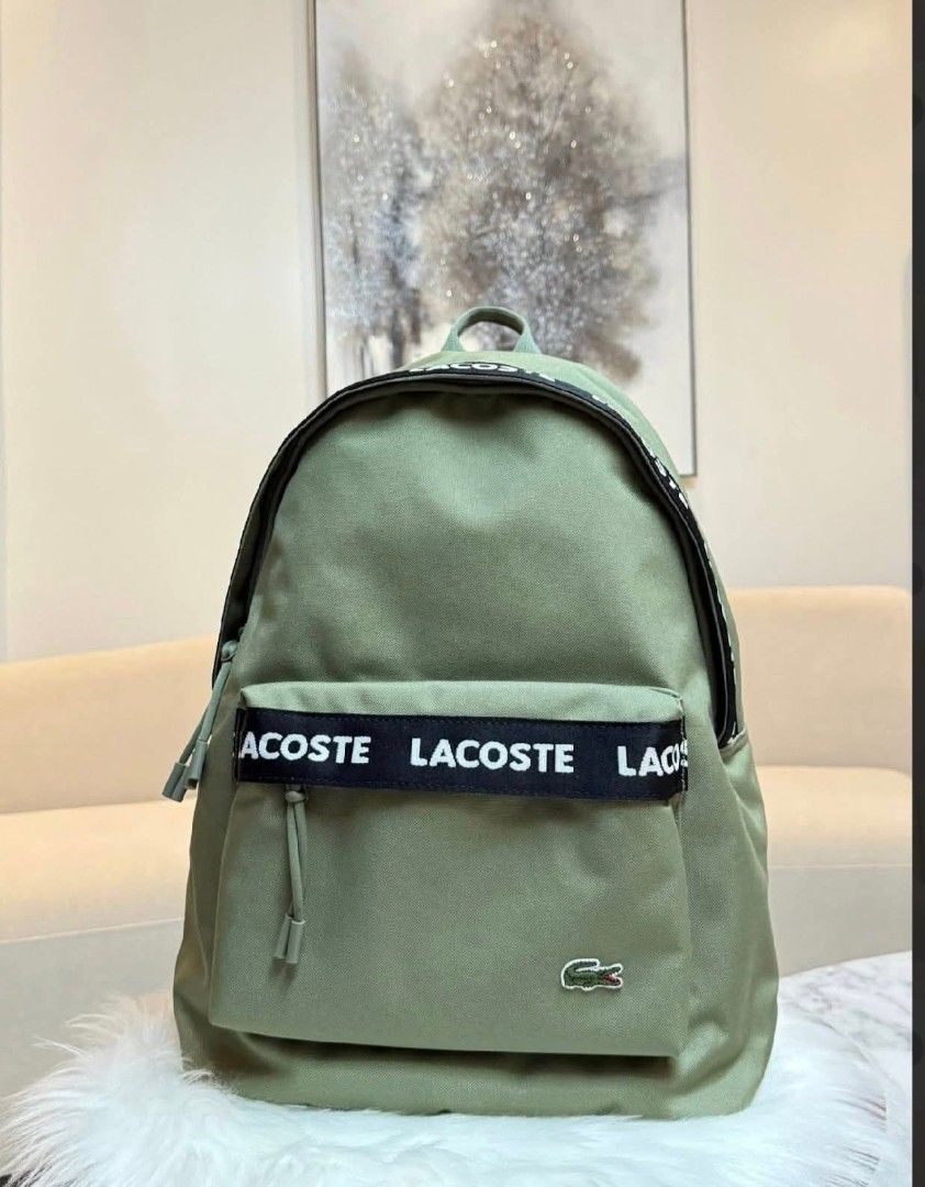 Lacoste Backpack - Multiple Colors Available (Category: Luxury Bags & Wallets) located in Makati City. Submitted by time.flip (Listing ID 1463142549, Image 1). Description: - Classic Lacoste backpack - Features iconic crocodile logo - Available in multiple colors (as shown) - Durable material, perfect for everyday use - Spacious main compartment - Convenient front zip pocket - Adjustable shoulder straps for comfort - Simple and stylish design.