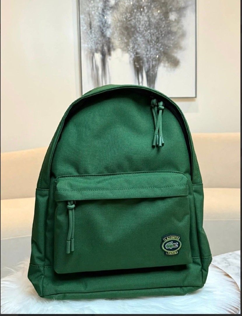 Lacoste Backpack - Multiple Colors Available (Category: Luxury Bags & Wallets) located in Makati City. Submitted by time.flip (Listing ID 1463142549, Image 2). Description: - Classic Lacoste backpack - Features iconic crocodile logo - Available in multiple colors (as shown) - Durable material, perfect for everyday use - Spacious main compartment - Convenient front zip pocket - Adjustable shoulder straps for comfort - Simple and stylish design.