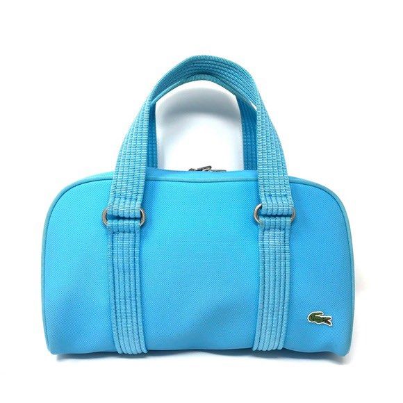 Lacoste Blue Canvas bowling Bag (Category: Luxury Bags & Wallets) located in Plaridel. Submitted by ilovebubu28 (Listing ID 1463274138, Image 1). Description: -light blue Lacoste boston bag - Made of durable canvas with light blue trim - Features the iconic crocodile logo on the side - Secure zipper closure - Ideal size for carrying your essentials - Comes with a dust bag for protection.