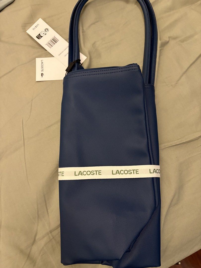 Lacoste Blue Tote Bag with Ribbon (Category: Tote Bags) located in Paranaque City. Submitted by max_bully014 (Listing ID 1462969489, Image 3). Description: - Authentic blue Lacoste tote bag - Comes with original ribbon and tags - Original price tag shows US$110 - Ideal for everyday use - Features a simple and chic design.