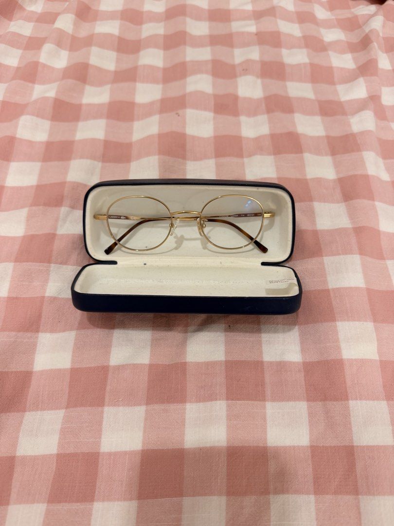 Lacoste Gold Round Eyeglasses with Case (Category: Sunglasses & Eyewear) located in Tuguegarao City. Submitted by joysmithznjo (Listing ID 1463124082, Image 3). Description: - Authentic Lacoste gold round eyeglasses - Comes with original navy blue hard case - Case has some internal markings.