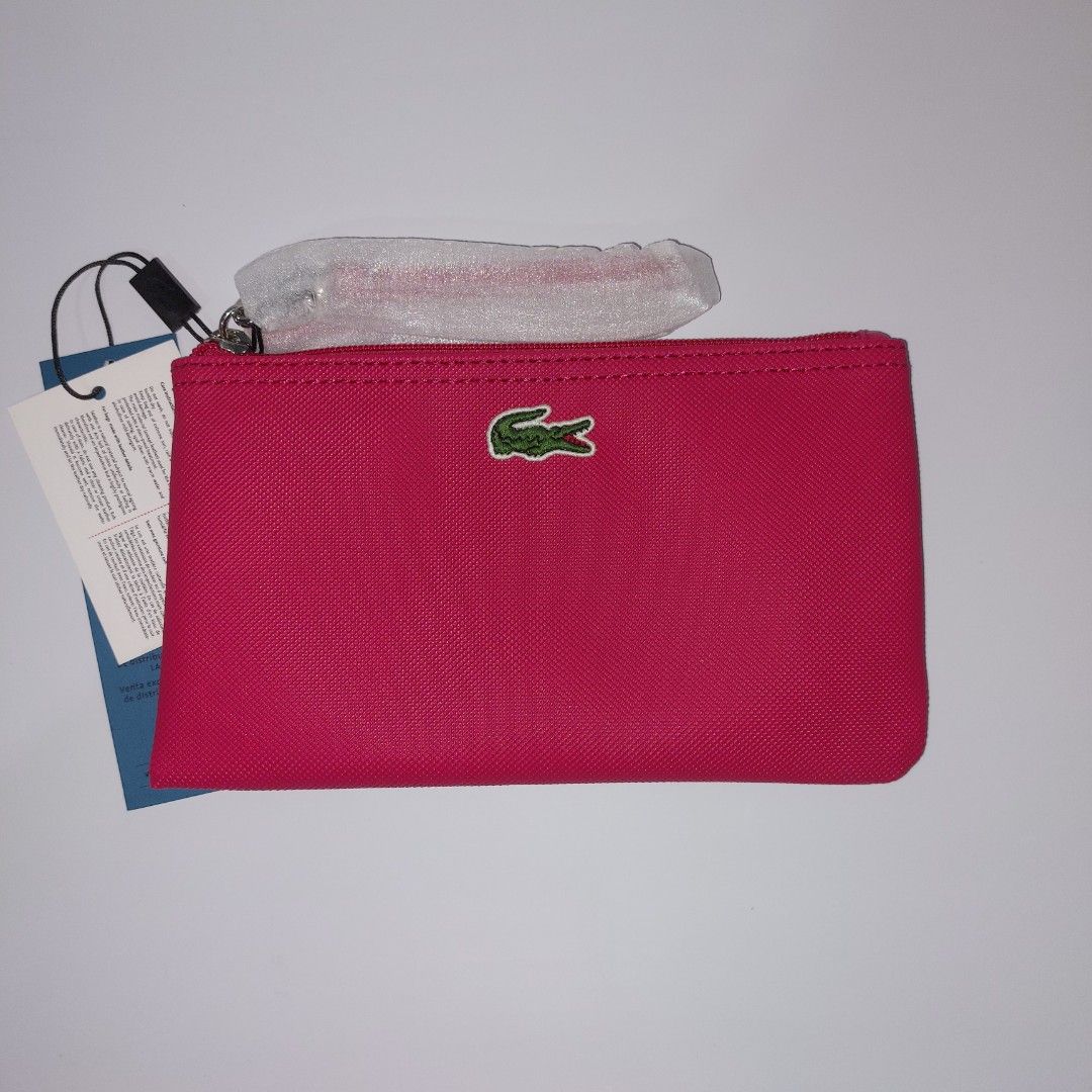 Lacoste Pink Pouch with Wrist Strap (Category: Purses & Pouches) located in Manila. Submitted by abbey.lee (Listing ID 1463202777, Image 1). Description: - Authentic Lacoste pink pouch - Features the iconic crocodile logo - Includes a detachable wrist strap for convenience - Ideal for organizing essentials - Great for travel or everyday use - Brand new with tags still attached.