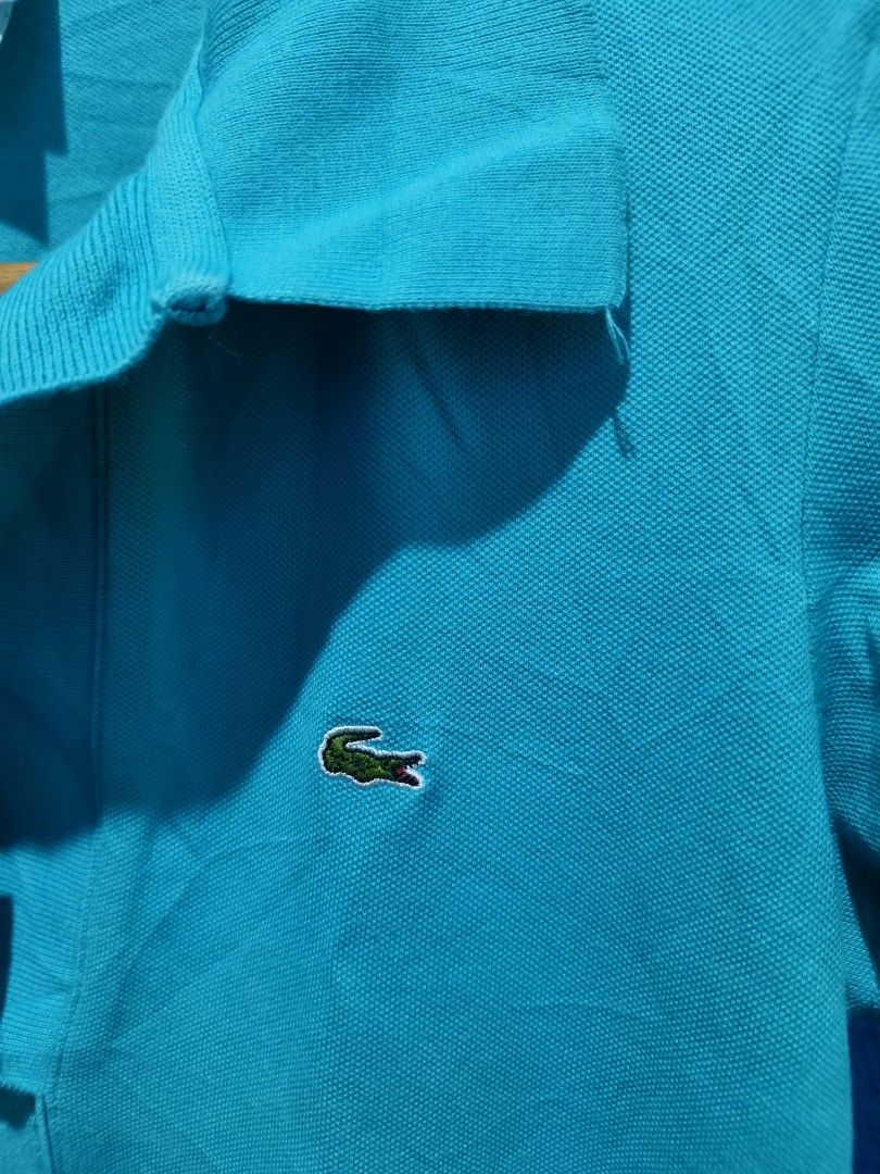 Lacoste Polo Shirt Size 38 Teal (Category: Others Tops) located in Davao. Submitted by vndrgd (Listing ID 1463120415, Image 3). Description: - Teal Lacoste Polo Shirt - Size: 38 - Measurements: Width 17.5 inches, Length 25 inches - Features iconic crocodile logo on chest - Made in China - Ideal for casual wear.