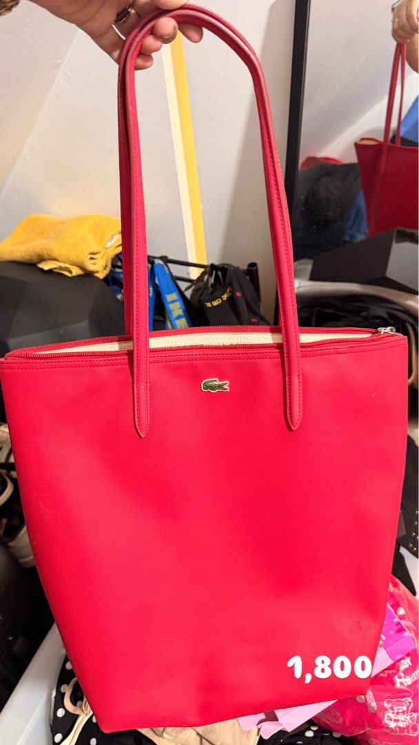 Lacoste Red Tote Bag (Category: Tote Bags) located in Santa Rosa. Submitted by hello2ndhandlove (Listing ID 1463142139, Image 2). Description: - Classic red Lacoste tote bag - Features the iconic crocodile logo - Spacious interior for all your essentials - Secure zip closure - Comfortable shoulder straps - Ideal for everyday use or travel Authentic.