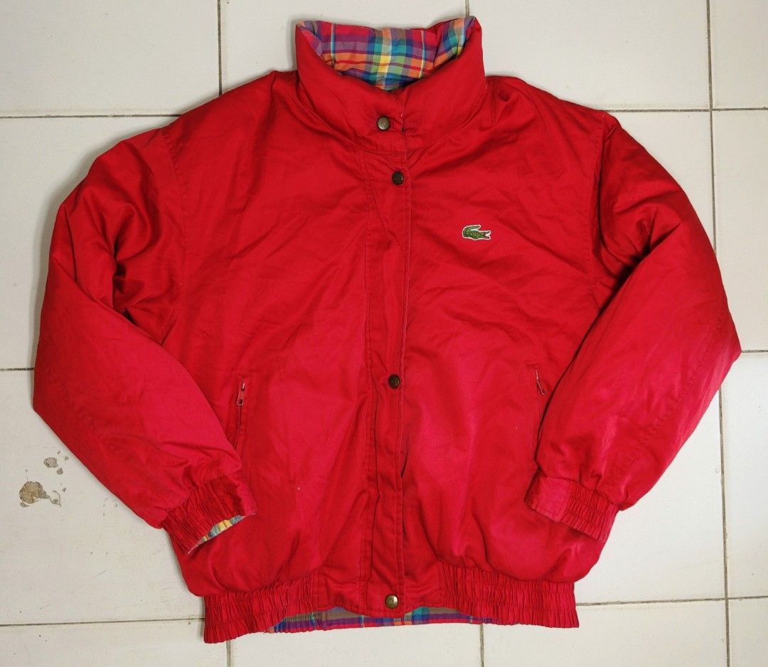 Lacoste Reversible Plaid Bomber Jacket Red (Category: Coats, Jackets and Outerwear) located in Manila. Submitted by teyobz_88 (Listing ID 1463161202, Image 1). Description: - Reversible Lacoste jacket - Side 1: Bright red with iconic crocodile logo - Side 2: Vibrant plaid pattern - Elasticated cuffs and hem - Zipper and button closure - Adds a pop of color to any outfit - Ideal for cooler weather - medium to large - 24x29 dimension.