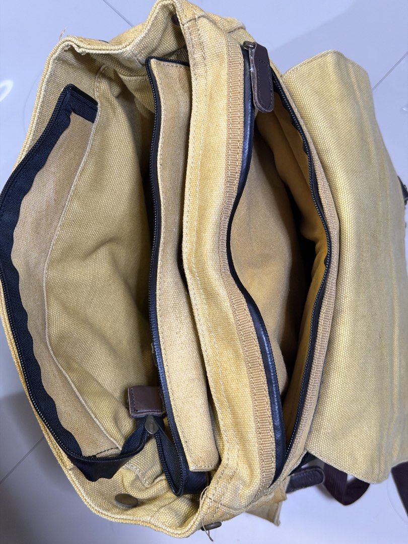 Langly Alpha Camera Bag (Category: Camera Bags & Carriers) located in Las Pinas. Submitted by fjoseiv (Listing ID 1463259462, Image 3). Description: - Khaki canvas backpack with stylish brown leather accents. - Multiple interior compartments, including padded sections for protection. - Two convenient front pockets with secure buckle closures. - Adjustable padded shoulder straps for comfortable carrying. - Versatile: perfect for everyday use or tr