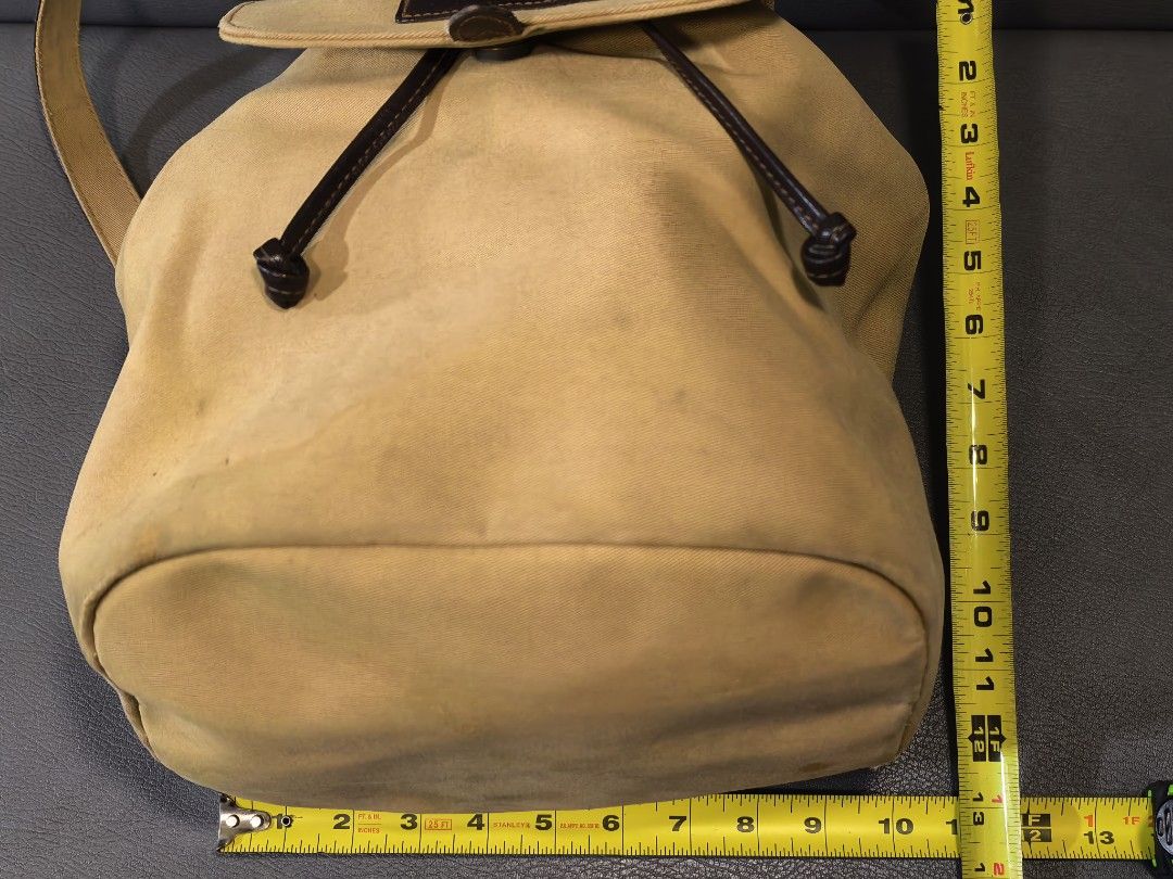 Lauren Ralph Lauren Canvas Drawstring Backpack Tan (Category: Backpacks) located in Cagayan de Oro. Submitted by pootx (Listing ID 1463270296, Image 2). Description: - Tan canvas backpack by Lauren Ralph Lauren - Features leather trim and drawstring closure - Includes an interior zip pocket - Minor marks on the exterior canvas - Ideal for everyday use - Made in Thailand - Approximate measurements: 12" tall, 9" wide.