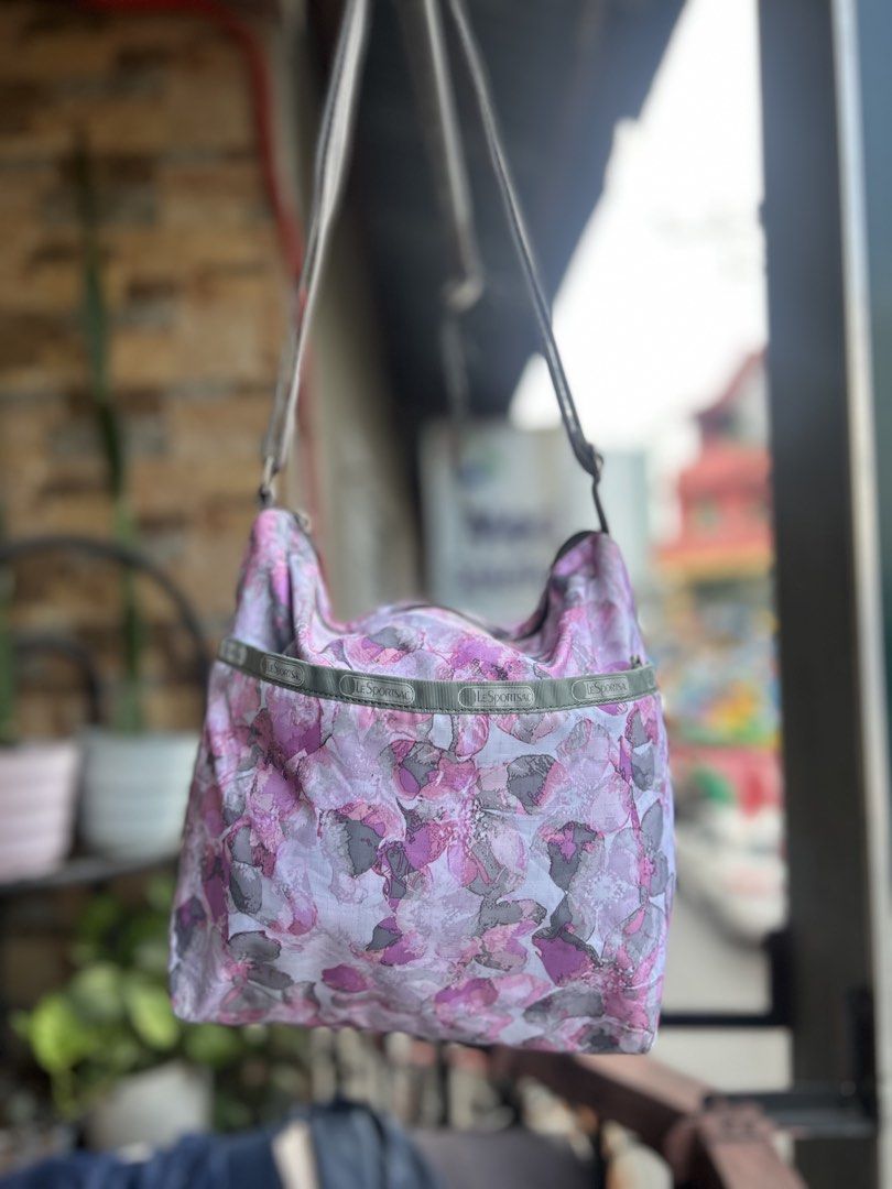 LeSportsac Floral Shoulder Bag (Category: Shoulder Bags) located in Cebu City. Submitted by yenetcuba52435 (Listing ID 1463133897, Image 2). Description: - Cute LeSportsac shoulder bag - Pretty purple and pink floral print - Main zippered compartment - Exterior pocket - Adjustable strap - Great for everyday use - Lightweight and practical.