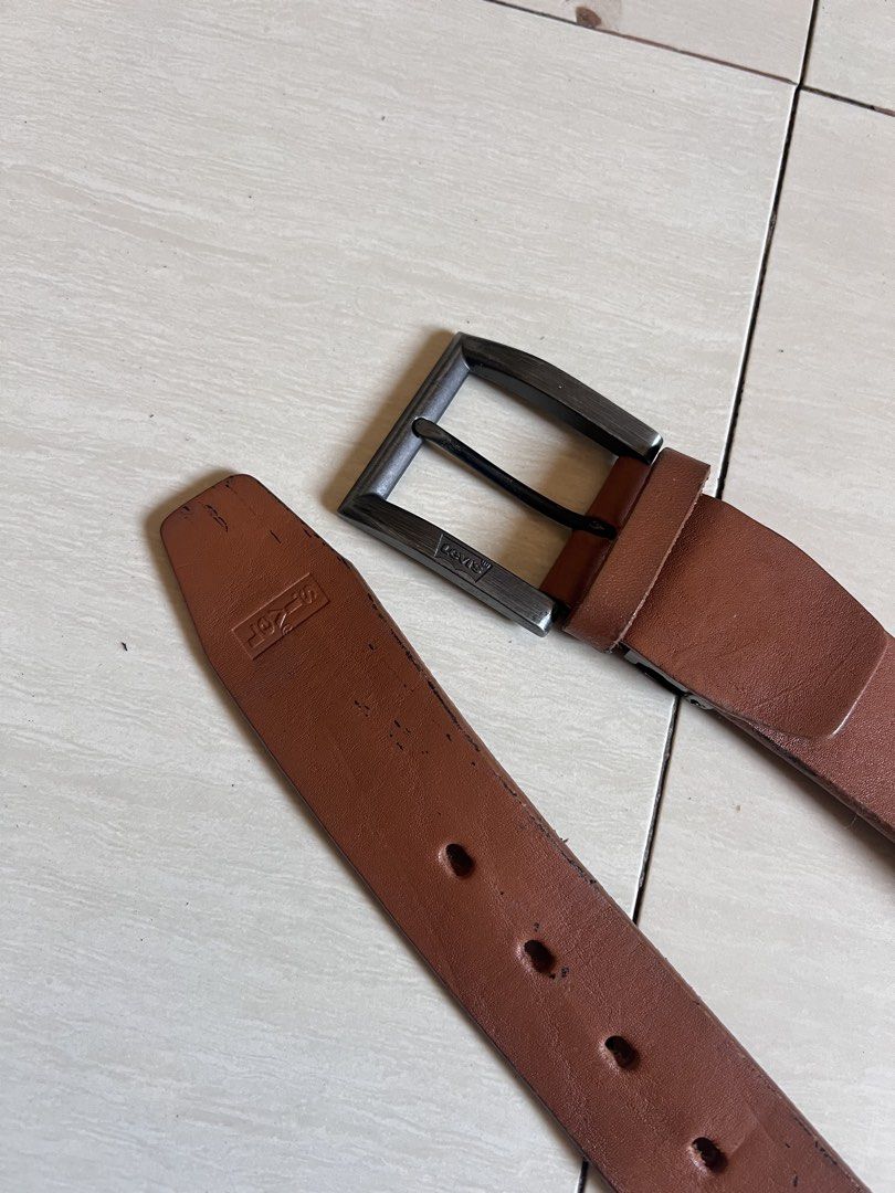 Levi's Brown Genuine Leather Belt (Category: Belts) located in Zamboanga. Submitted by safe.haimer (Listing ID 1463230323, Image 2). Description: - Genuine Levi's brown leather belt - Dark metal buckle - Made in China - Shows some signs of wear on leather and edges - Still a solid and durable belt for everyday wear.