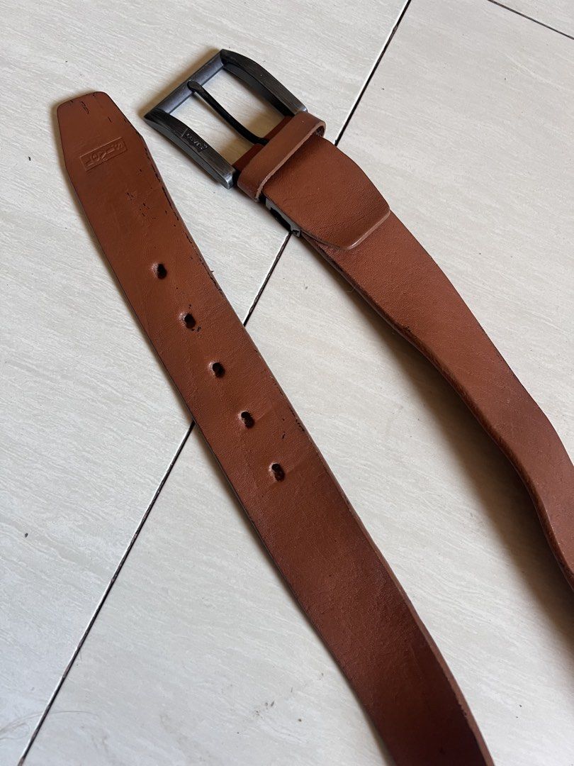 Levi's Brown Genuine Leather Belt (Category: Belts) located in Zamboanga. Submitted by safe.haimer (Listing ID 1463230323, Image 3). Description: - Genuine Levi's brown leather belt - Dark metal buckle - Made in China - Shows some signs of wear on leather and edges - Still a solid and durable belt for everyday wear.