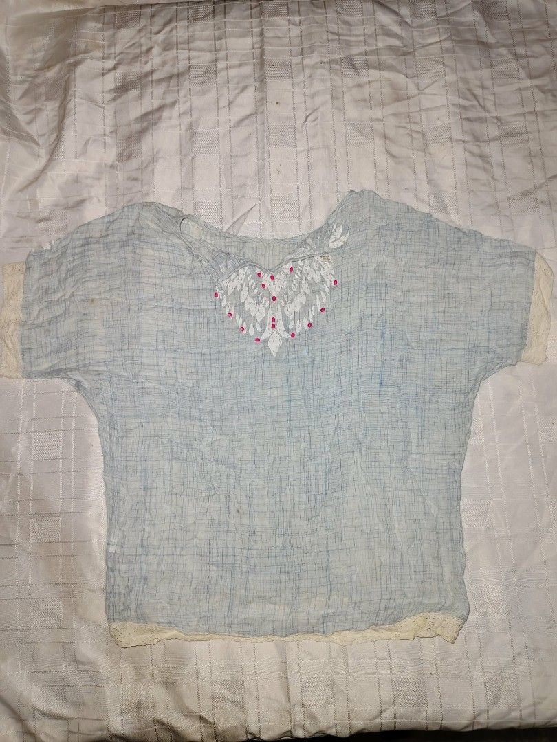 Light Blue Embroidered Top with Lace Trim (Category: Others Tops) located in Manila. Submitted by ck.key (Listing ID 1463204582, Image 1). Description: Light blue top with a textured weave. Features a heart-shaped embroidery with pink bead accents on the chest. Short sleeves and hem have delicate lace trim. Some minor marks are visible on the fabric. Great for a casual, bohemian look..