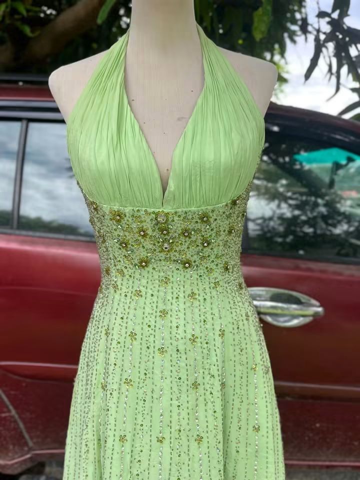 Lime Green Halter Neck Beaded Maxi Dress (Category: Dresses) located in Adams. Submitted by swiftrabbit (Listing ID 1463261339, Image 2). Description: - Eye-catching lime green maxi dress - Halter neck design - Intricate bead and sequin embellishments on bodice and skirt - Elegant open back - Flowy skirt for graceful movement - Ideal for parties, weddings, and formal occasions - whimsy - has issues of loss beads & clips.