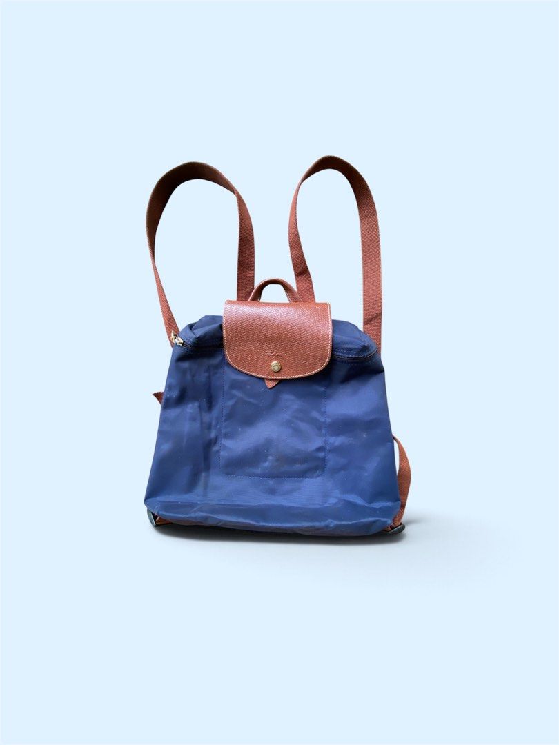 Longchamp Le Pliage Backpack Navy Blue Leather Trim (Category: Backpacks) located in Dapitan. Submitted by bolandojh07634 (Listing ID 1463281352, Image 1). Description: - Classic Longchamp backpack in navy blue - Iconic leather flap and handles - Secure zipper closure with horse logo pull - Spacious interior, ideal for everyday or travel - Adjustable straps for comfortable wear.