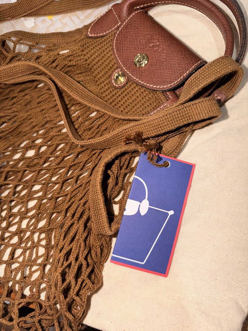 Longchamp Le Pliage Filet Tote Bag Brown (Category: Luxury Bags & Wallets) located in Las Pinas. Submitted by twiceloved24 (Listing ID 1463263182, Image 2). Description: Bought for almost ₱9,000 Used once only - will pass as brand new! with tags + ziplock Selling for ₱7,000.