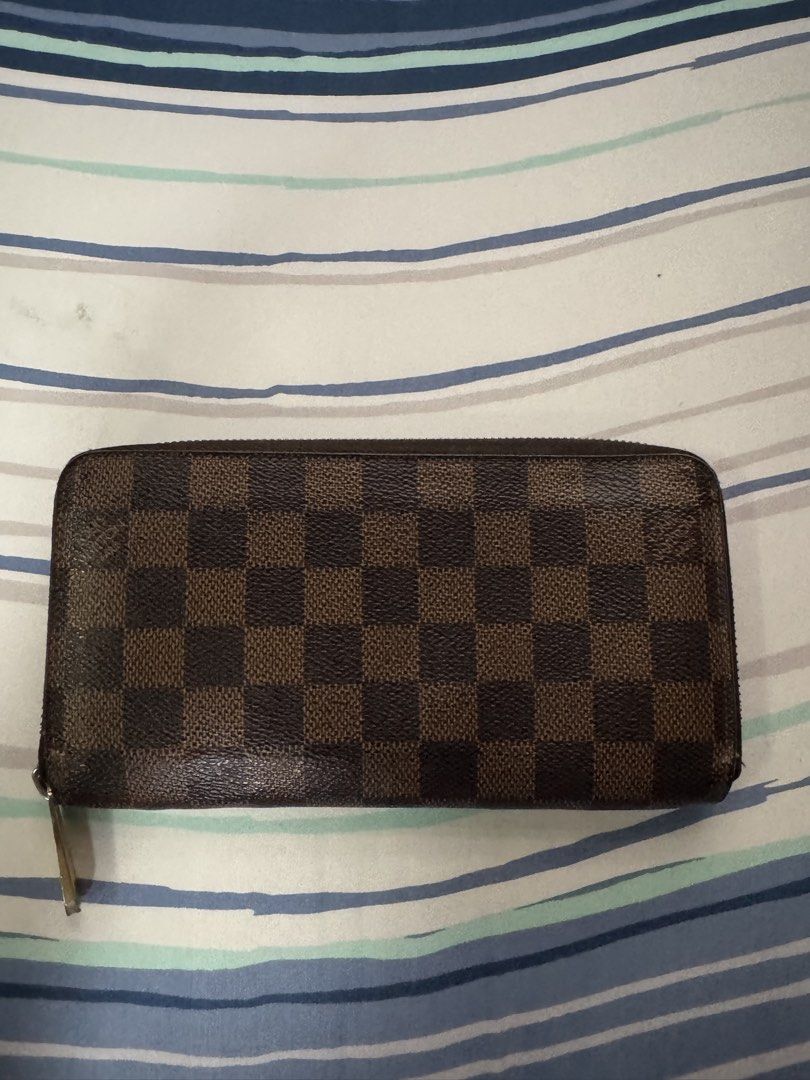 Louis Vuitton Damier Ebene Canvas Long Wallet (Category: Luxury Bags & Wallets) located in Paranaque City. Submitted by tripleddd151025 (Listing ID 1463157666, Image 1). Description: - Authentic Louis Vuitton Wallet - Damier Ebene Canvas - Zip Around Closure - Multiple Card Slots & Compartments for Organization - Minor Signs of Wear on Zipper Pull and Interior - Classic and Timeless Piece.