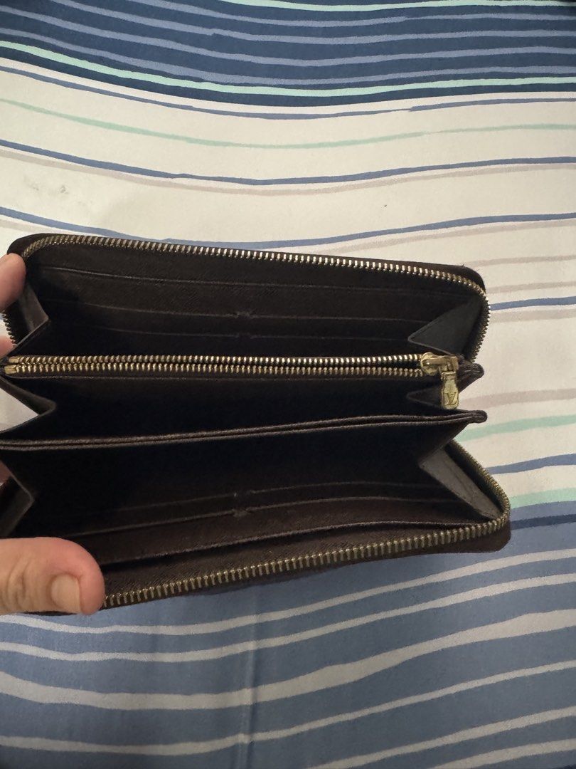 Louis Vuitton Damier Ebene Canvas Long Wallet (Category: Luxury Bags & Wallets) located in Paranaque City. Submitted by tripleddd151025 (Listing ID 1463157666, Image 2). Description: - Authentic Louis Vuitton Wallet - Damier Ebene Canvas - Zip Around Closure - Multiple Card Slots & Compartments for Organization - Minor Signs of Wear on Zipper Pull and Interior - Classic and Timeless Piece.