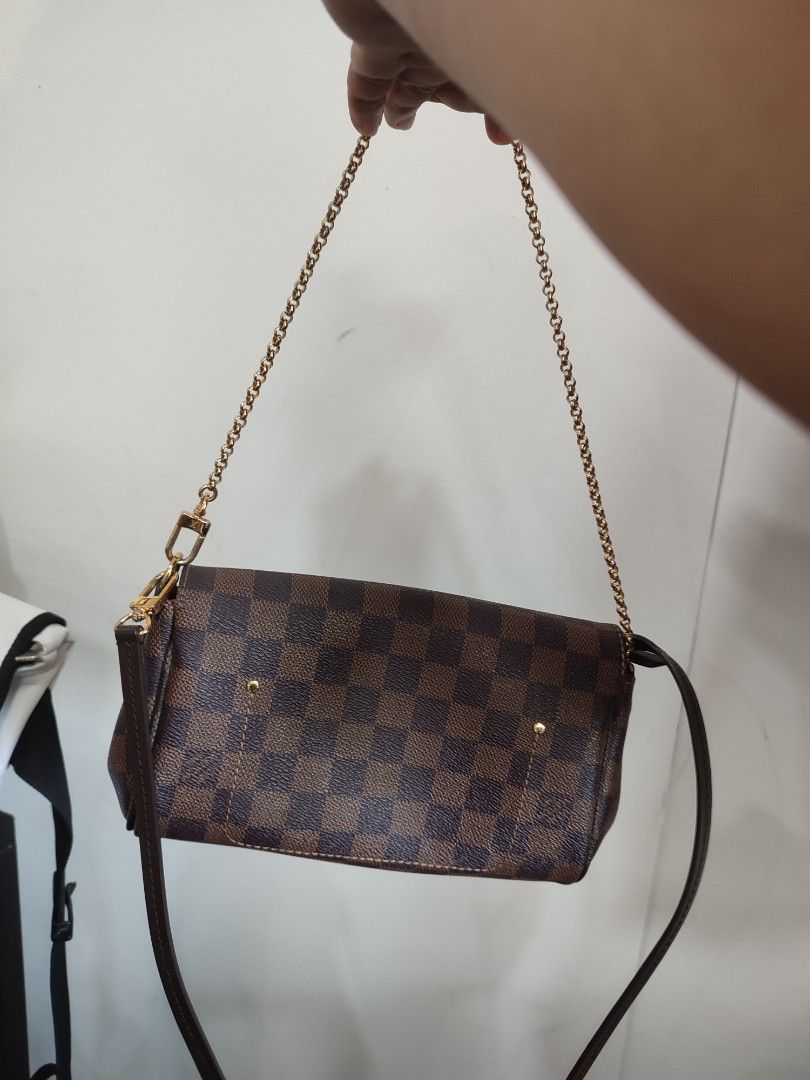 Louis Vuitton Damier Ebene Small Shoulder Bag (Category: Luxury Bags & Wallets) located in Puerto Princesa. Submitted by thriftedsoulsy2k (Listing ID 1463154414, Image 3). Description: - Louis Vuitton Damier Ebene canvas - Features a gold chain strap - Small size, ideal for carrying essentials - Versatile: can be worn as a shoulder bag or crossbody - Interior is clean - Minor signs of wear on leather trim and hardware, consistent with normal use 