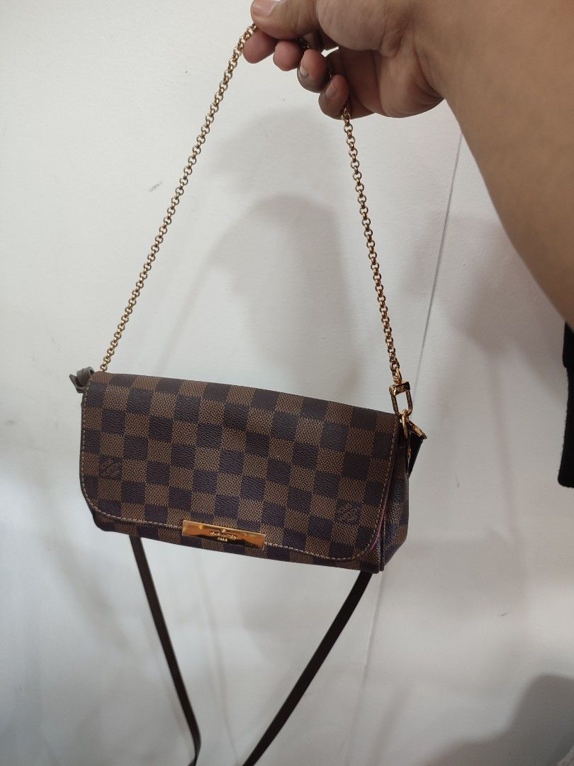 Louis Vuitton Damier Ebene Small Shoulder Bag (Category: Luxury Bags & Wallets) located in Puerto Princesa. Submitted by thriftedsoulsy2k (Listing ID 1463154414, Image 2). Description: - Louis Vuitton Damier Ebene canvas - Features a gold chain strap - Small size, ideal for carrying essentials - Versatile: can be worn as a shoulder bag or crossbody - Interior is clean - Minor signs of wear on leather trim and hardware, consistent with normal use 
