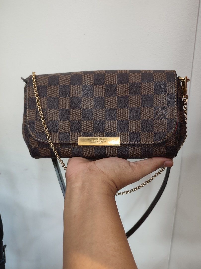 Louis Vuitton Damier Ebene Small Shoulder Bag (Category: Luxury Bags & Wallets) located in Puerto Princesa. Submitted by thriftedsoulsy2k (Listing ID 1463154414, Image 1). Description: - Louis Vuitton Damier Ebene canvas - Features a gold chain strap - Small size, ideal for carrying essentials - Versatile: can be worn as a shoulder bag or crossbody - Interior is clean - Minor signs of wear on leather trim and hardware, consistent with normal use 