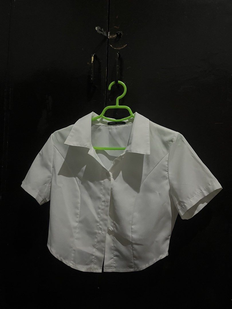 Lovito White Cropped Button-Up Shirt (Category: Shirts) located in Caloocan City. Submitted by allennaint18459 (Listing ID 1463243736, Image 2). Description: - NEVER BEEN WORN -White cropped shirt - Short sleeves - Button-up front with collar - Fitted style - Pairs well with high-waisted jeans or skirts - Versatile wardrobe staple.