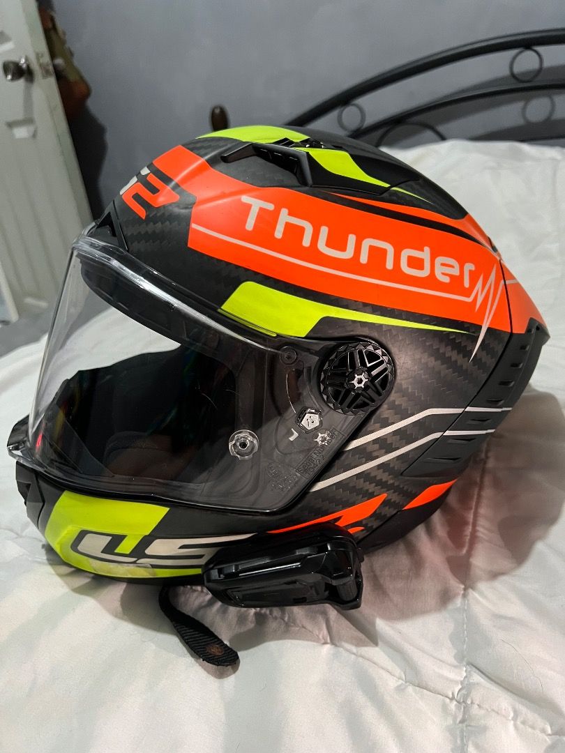 LS2 Thunder Motorcycle Helmet (Category: Helmets and other Riding Gears) located in Caloocan City. Submitted by purepenguin.097493 (Listing ID 1463213748, Image 3). Description: - LS2 Thunder Helmet - Striking design: Bright orange, neon yellow, and black - Stylish carbon fiber look - Comes with a clear visor - Integrated Bluetooth communicator - Perfect for your next motorcycle adventure!.