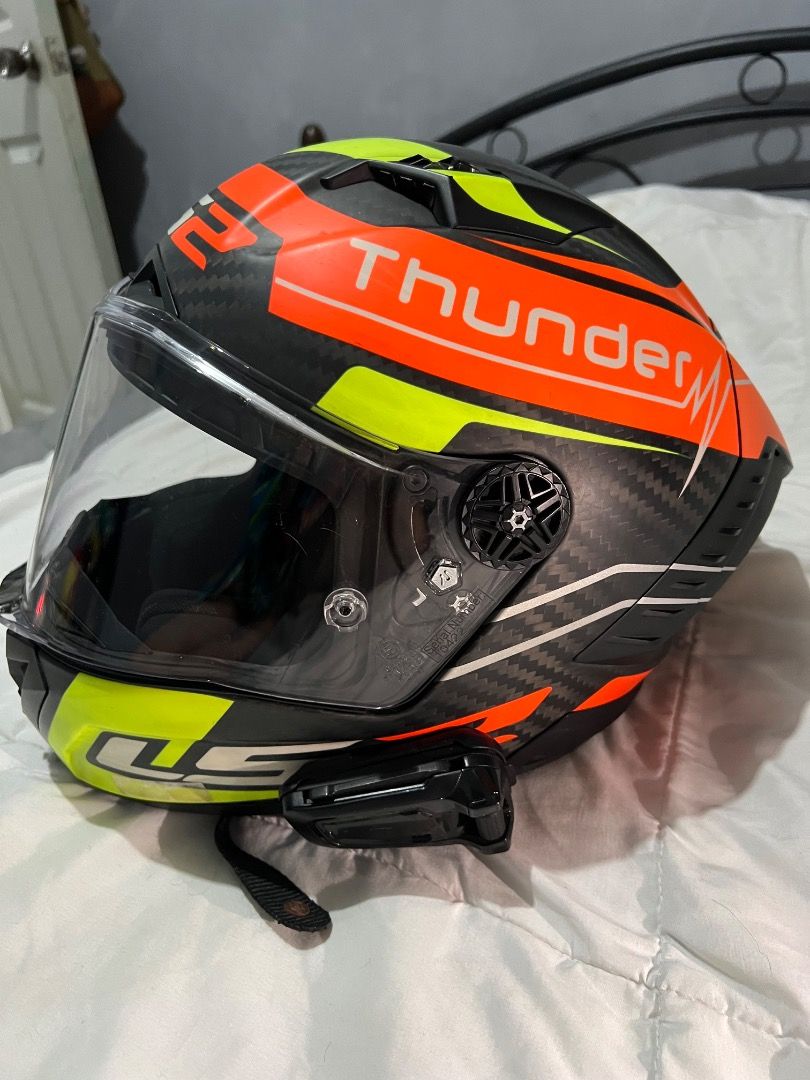 LS2 Thunder Motorcycle Helmet (Category: Helmets and other Riding Gears) located in Caloocan City. Submitted by purepenguin.097493 (Listing ID 1463213748, Image 2). Description: - LS2 Thunder Helmet - Striking design: Bright orange, neon yellow, and black - Stylish carbon fiber look - Comes with a clear visor - Integrated Bluetooth communicator - Perfect for your next motorcycle adventure!.