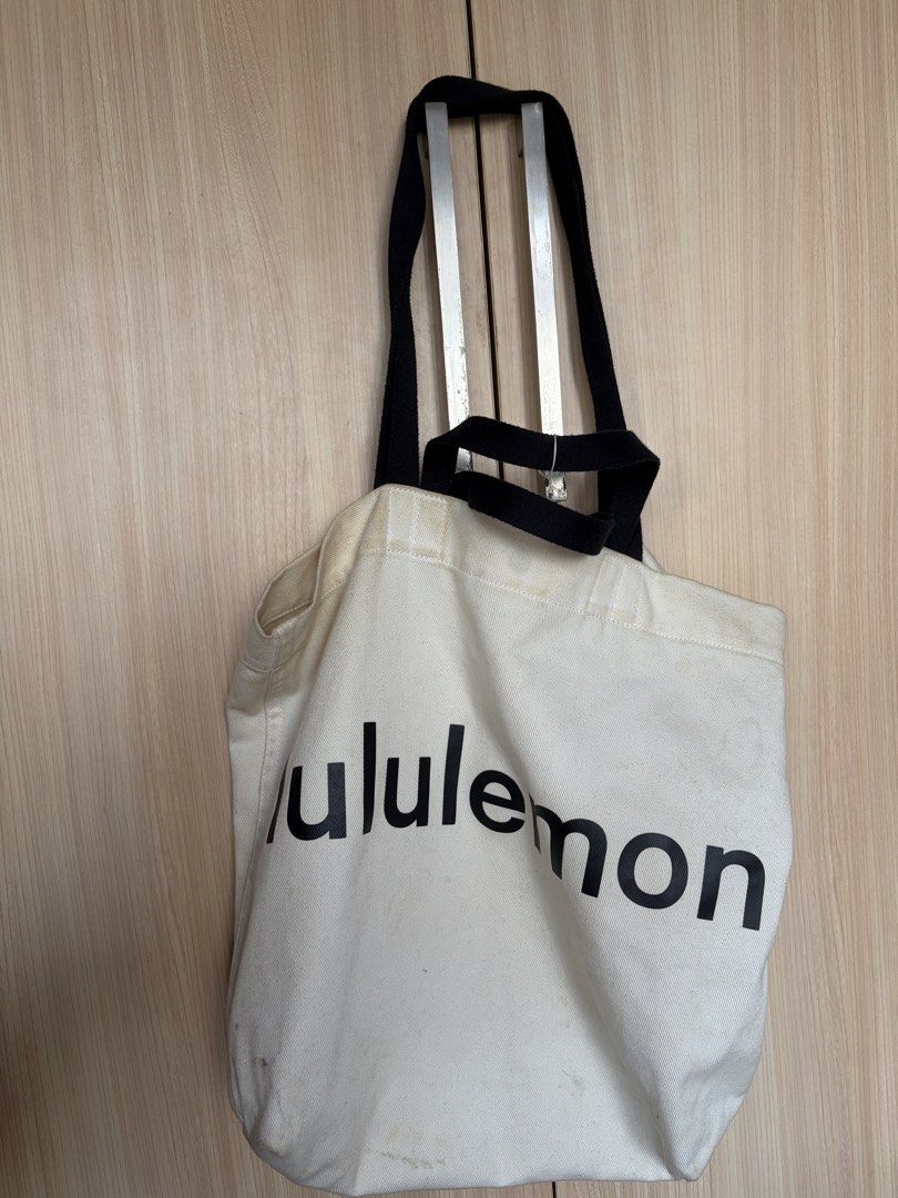 Lululemon Canvas Tote Bag (Category: Tote Bags) located in Taguig. Submitted by imgthrift (Listing ID 1463207853, Image 2). Description: - Classic Lululemon tote bag - Color: Cream canvas with black handles and logo - Size: Good for everyday use, groceries, or carrying essentials.