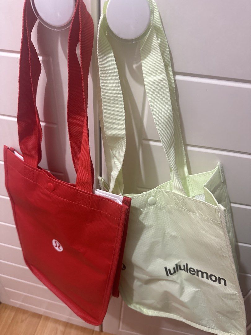 Lululemon Tote Bags (Red & Light Green) (Category: Tote Bags) located in Antipolo. Submitted by ririwearph (Listing ID 1463232484, Image 2). Description: - Two Lululemon reusable tote bags - One red bag with Lululemon logo - One light green bag with full Lululemon wordmark - Ideal for groceries or everyday errands - Features a convenient snap closure at the top.