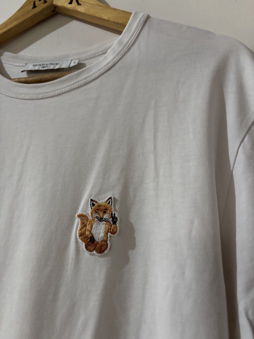 Maison Kitsuné White Tee with Fox Logo (Category: Tshirts & Polo Shirts ) located in Kalibo. Submitted by mack29 (Listing ID 1463128697, Image 2). Description: - Authentic Maison Kitsuné T-shirt - Classic white color - Features iconic embroidered fox logo on chest - Made in Portugal - 100% premium cotton - Size: Medium (M) - Ideal for casual and stylish everyday wear.