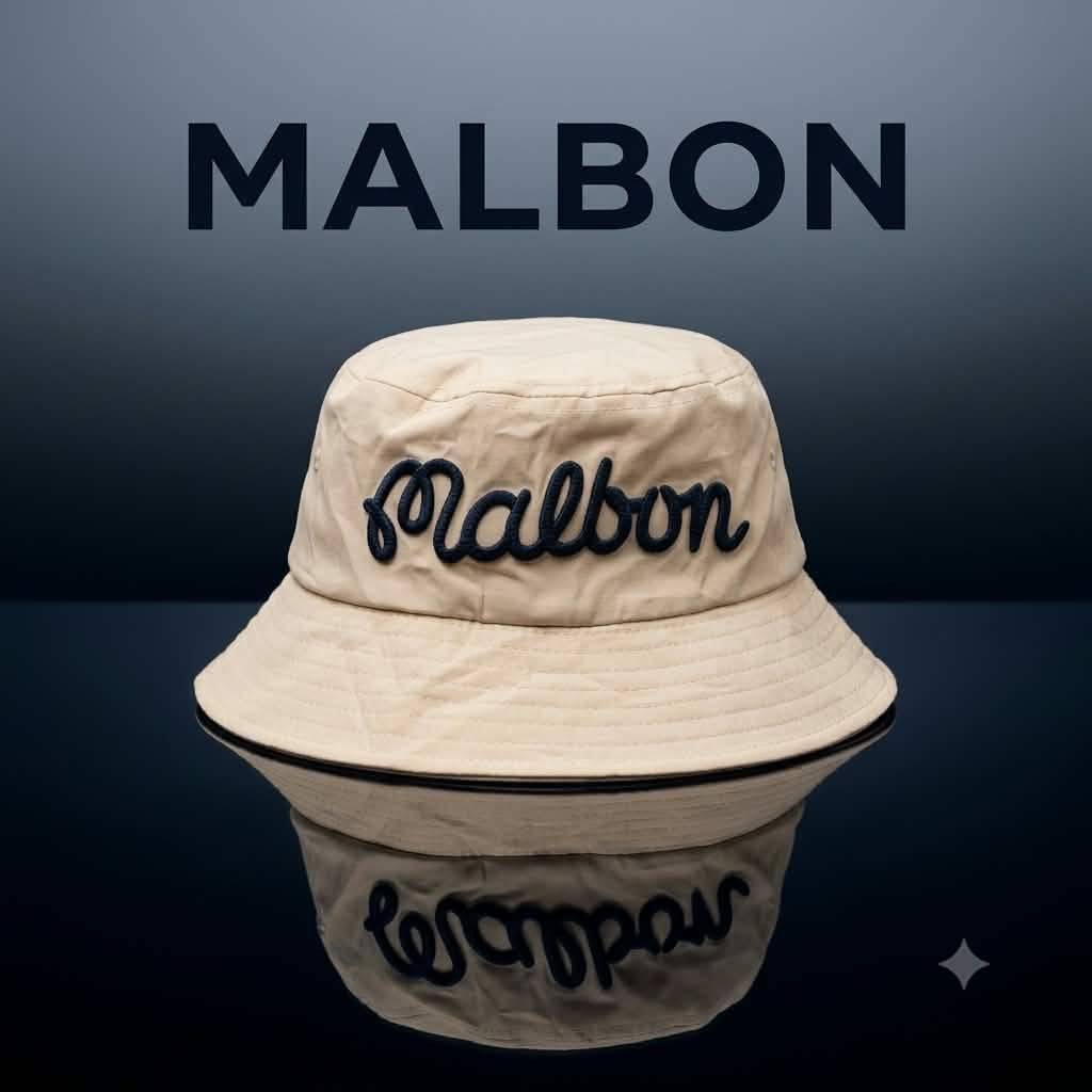 Malbon Golf Bucket Hat - Beige (Category: Caps & Hats) located in Carmen. Submitted by rr_thrifts (Listing ID 1463273450, Image 1). Description: - Cool Malbon bucket hat - Beige color with navy blue embroidery - Malbon logo on the front - Fun golf graphic on the side - Ideal for sunny days, on or off the golf course - One size fits most.