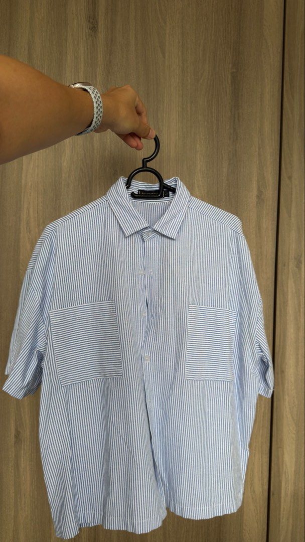 Man Striped Short Sleeve Shirt (Category: Tshirts & Polo Shirts ) located in Manila. Submitted by jmbb00.03 (Listing ID 1463136794, Image 1). Description: - Light blue and white striped short sleeve shirt - Button-up front - Two chest pockets - Relaxed fit - Perfect for casual wear - Easy to style with jeans or shorts.