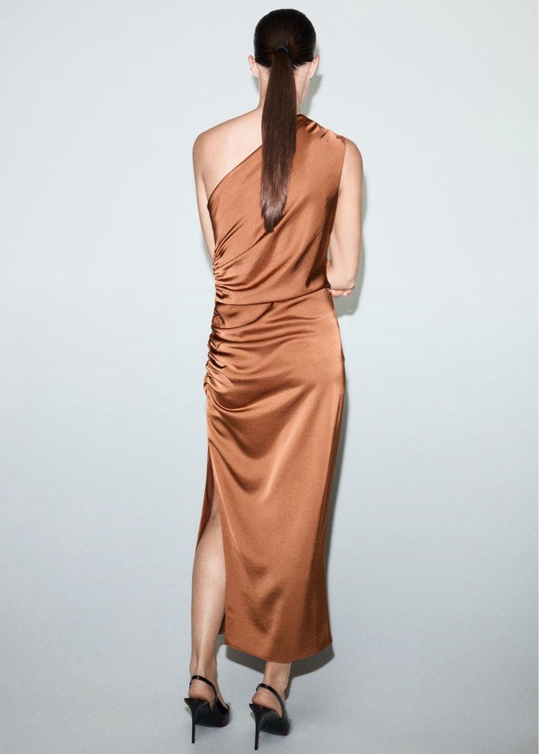 Formal Mango Satin One-Shoulder Ruched Dress (Category: Dresses) located in Makati City. Submitted by thinktin18 (Listing ID 1463265726, Image 2). Description: - Beautiful satin dress in a rich bronze/copper color. - Elegant one-shoulder design. - Flattering ruching detail on the side. - Features a stylish high slit. - Perfect for dressing up or down, ideal for nights out or special events.