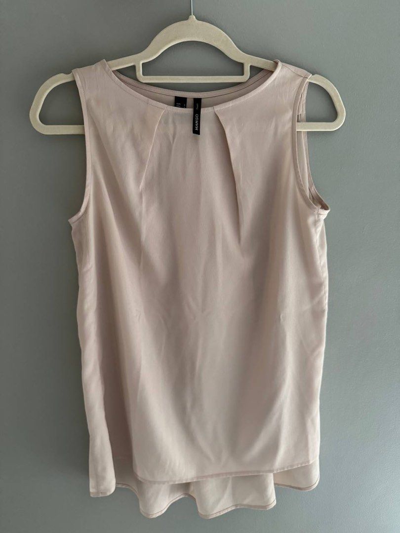 Mango Suit Sleeveless Top - Size S (Category: Sleeveless) located in Taguig. Submitted by anxmz (Listing ID 1463144534, Image 1). Description: - Mango Suit sleeveless top - Light pink/beige color - Pleat details at the neckline - Simple and chic design - Ideal for layering or wearing solo - Easily dressed up or down.
