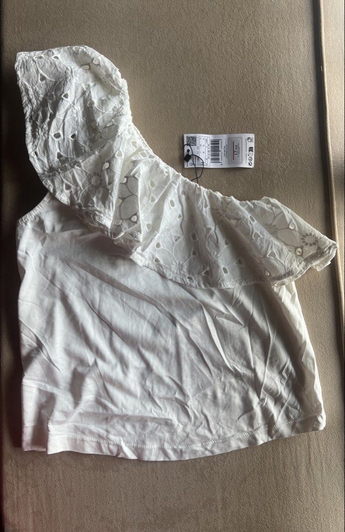 Mango White Eyelet One Shoulder Top (Category: Sleeveless) located in Cagayan de Oro. Submitted by jeirn (Listing ID 1463119246, Image 1). Description: - Brand: Mango - Style: White one-shoulder top - Features: Eyelet detailing on the ruffle - Size: Medium (M) - Condition: Brand new with original tags attached - Reason for selling: Never worn.