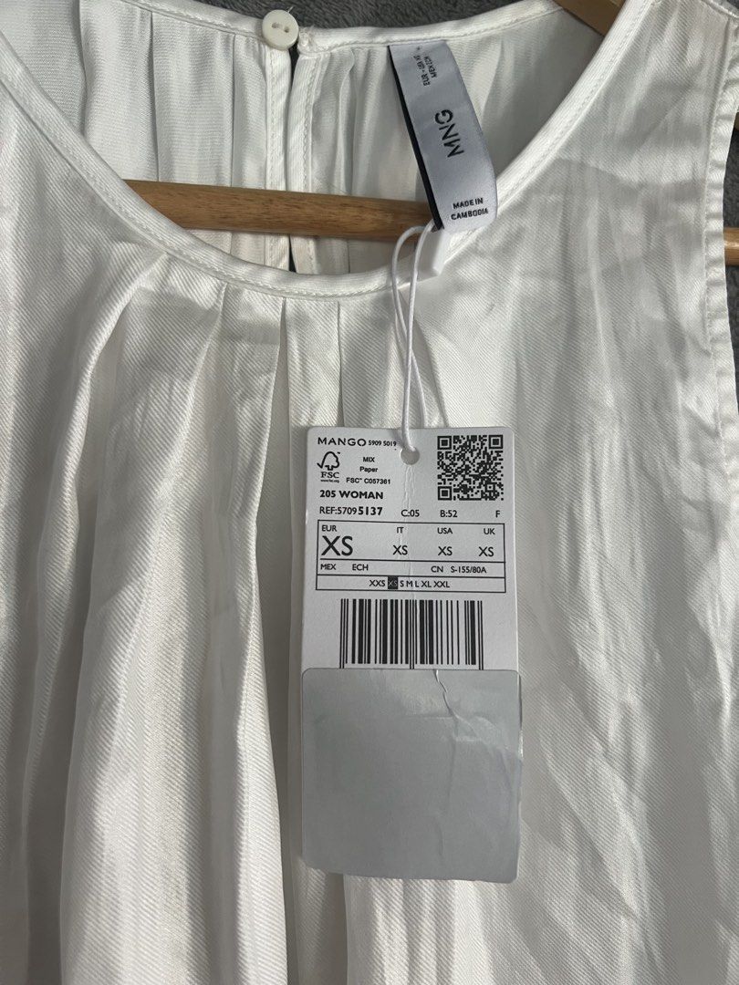 Mango White Sleeveless Pleated Top flowy XS (Category: Sleeveless) located in Cagayan de Oro. Submitted by jeirn (Listing ID 1463120787, Image 2). Description: - White sleeveless top from Mango - Features elegant pleats at the front neckline - Convenient button closure at the back - Simple and clean design, versatile for any outfit - Ideal for layering or wearing on its own - Size XS.