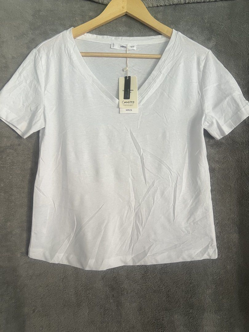 Mango White V-Neck T-Shirt Committed Collection Size S (Category: Shirts) located in Cagayan de Oro. Submitted by jeirn (Listing ID 1463124480, Image 1). Description: - MNG White V-neck T-shirt - Size: S - Part of the 'Committed' collection (eco-friendly & recycled fabrics) - Regular fit - Ideal for everyday wear.