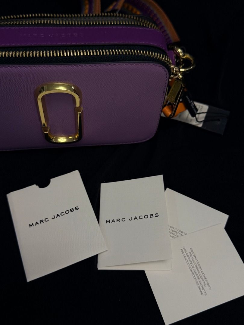Marc Jacobs Snapshot Camera Bag Purple Gold Hardware (Category: Luxury Bags & Wallets) located in Caloocan City. Submitted by grandbear.ee4db0 (Listing ID 1463206629, Image 2). Description: MARC JACOBS THE SNAPSHOT ₱15,000 | Negotiable | Open for offers Specifications: • Model: The Snapshot • Color: Regal Orchid Multi • Style Code: H172L01SP22-518 • Material: Saffiano Leather • Size: 18 × 6 × 11 cm • Details: Double-Zip Compartments, Signature J 