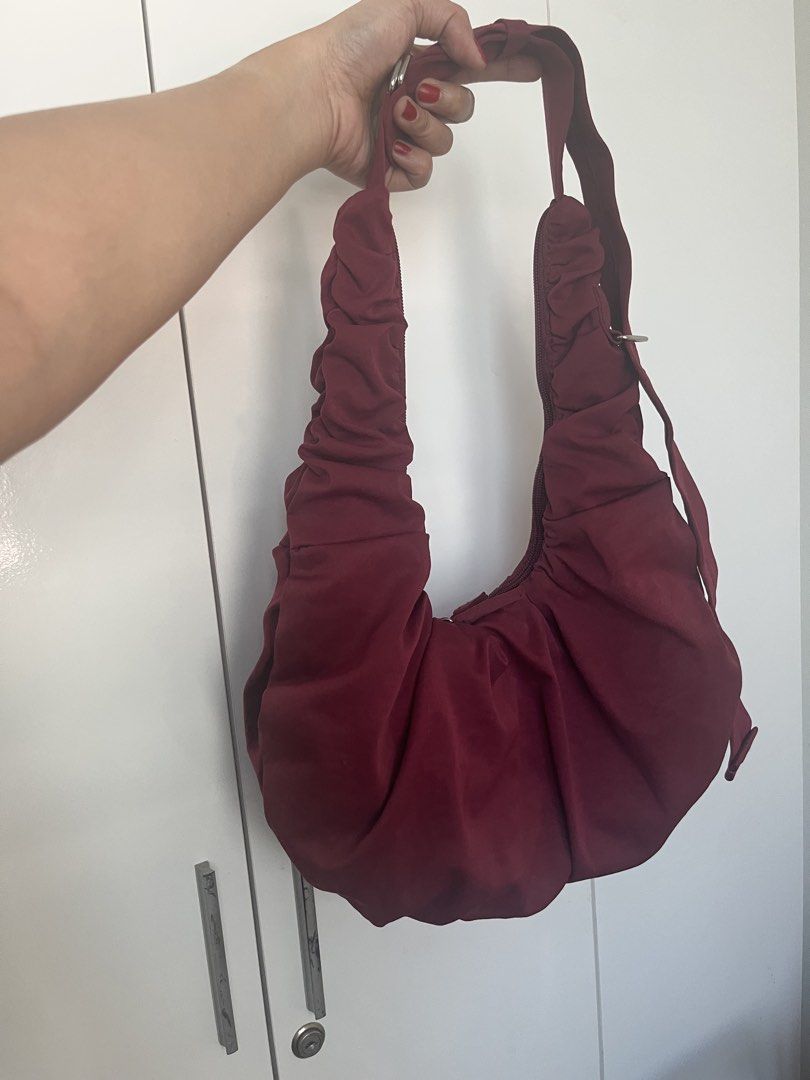 Maroon Ruched Shoulder Bag (Category: Shoulder Bags) located in Mandaluyong City. Submitted by jackiemochi (Listing ID 1463171351, Image 1). Description: - Stylish maroon shoulder bag - Unique ruched detailing all over - Secure top zipper closure - Adjustable strap with buckle for a custom fit - Convenient interior pockets - Ideal for everyday wear.