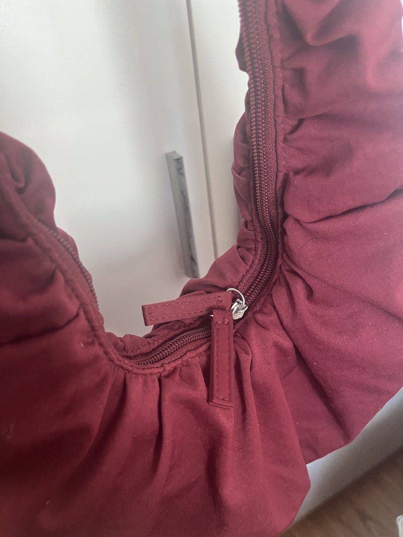 Maroon Ruched Shoulder Bag (Category: Shoulder Bags) located in Mandaluyong City. Submitted by jackiemochi (Listing ID 1463171351, Image 3). Description: - Stylish maroon shoulder bag - Unique ruched detailing all over - Secure top zipper closure - Adjustable strap with buckle for a custom fit - Convenient interior pockets - Ideal for everyday wear.